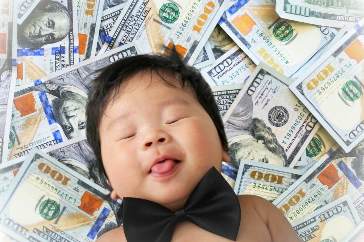 Born Into Wealth A sleeping baby in a black bow tie lying on a bed of hundred-dollar bills, with a peaceful expression, representing the notion of wealth from birth.