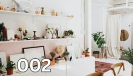 White wooden shelf with various decor items arranged neatly in a minimalistic interior.