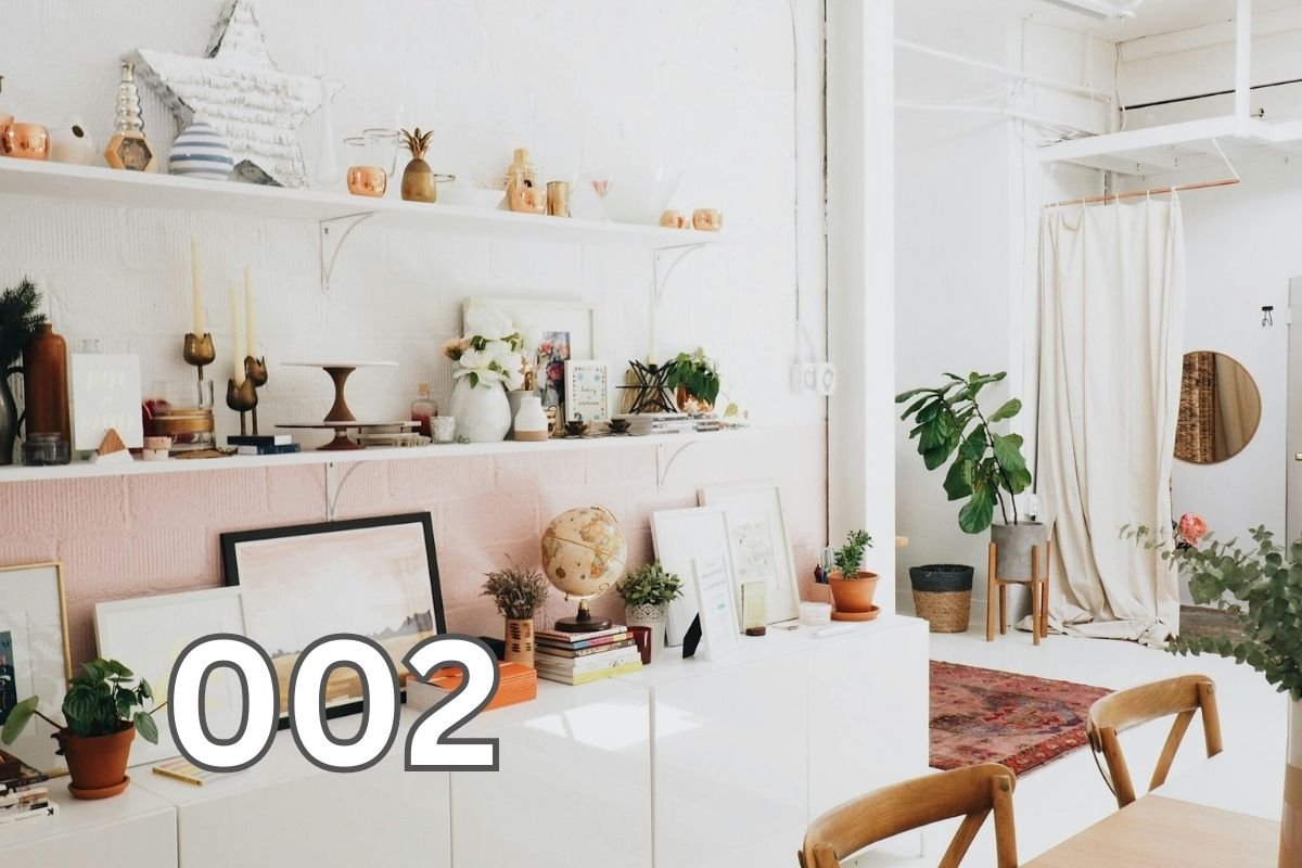White wooden shelf with various decor items arranged neatly in a minimalistic interior.