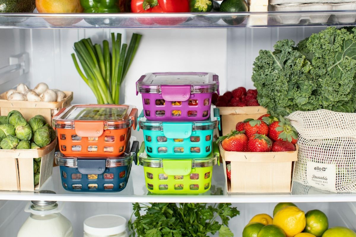 Neatly arranged containers and fresh produce in a refrigerator.
