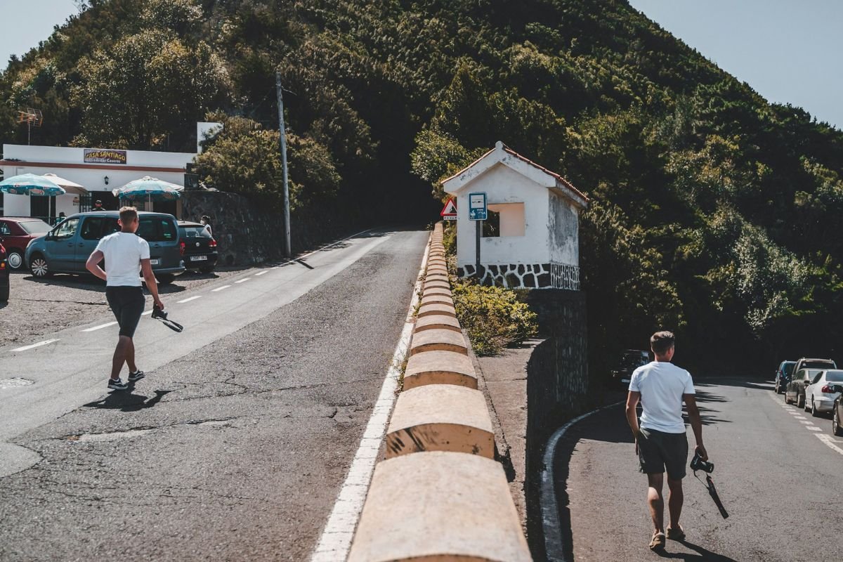 Two people walking away from each other on a quiet road, symbolising growing apart.