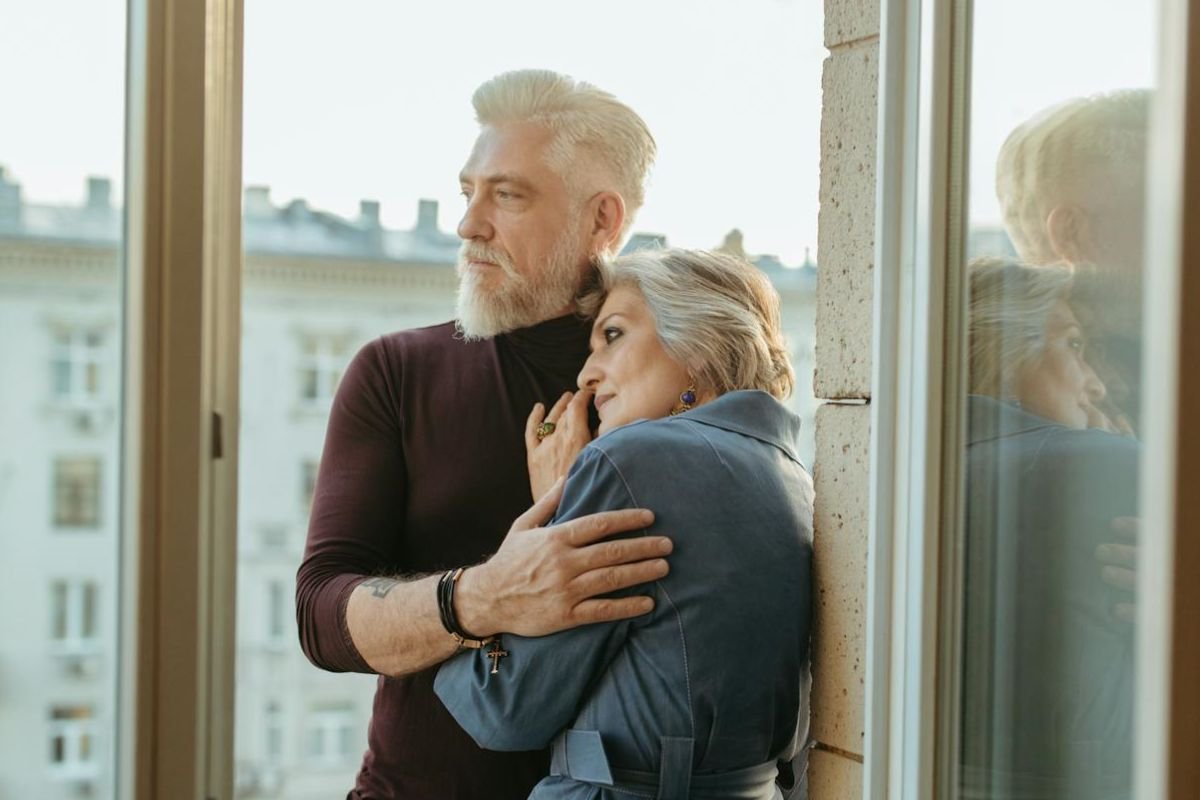Respect and Live Harmoniously: A Loving Embrace Between Partners An older couple embracing lovingly on a sunny day, highlighting the bond of respect and harmony in their relationship.