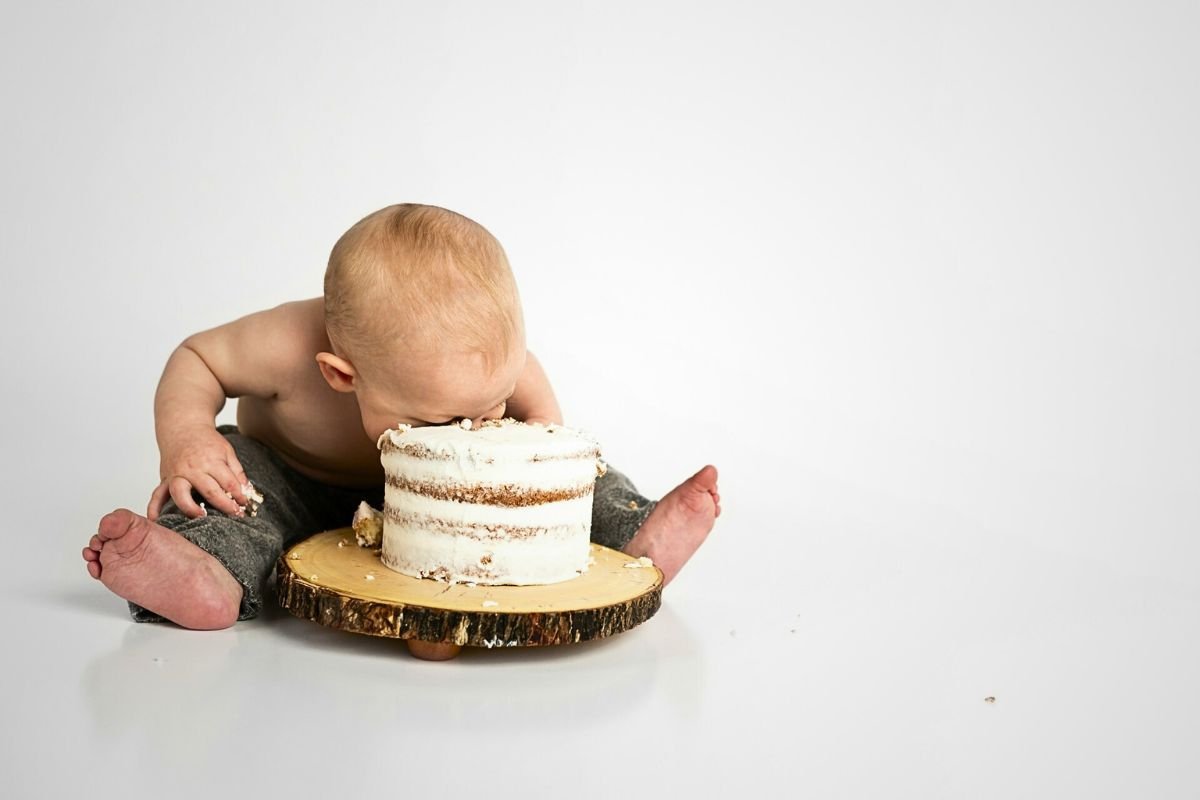 Think Before You Bite: Is Your Food the Real Deal? Close-up of a child sitting beside a round cake, questioning if the treat is truly what it seems.