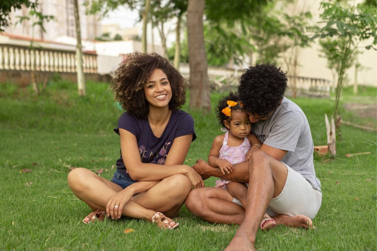 Respecting Boundaries: Supporting Your Children as They Start Their Own Families A young family sitting together at the park, representing the importance of respecting privacy and boundaries as children start their own families.