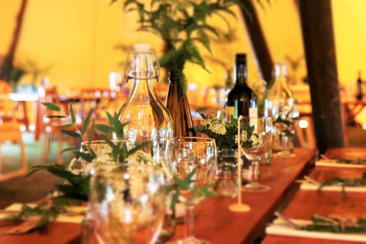 Elegant Dinner Table with Wine and Utensils A beautifully set dinner table with wine glasses, wine bottles, and utensils, symbolising social connections and shared moments.