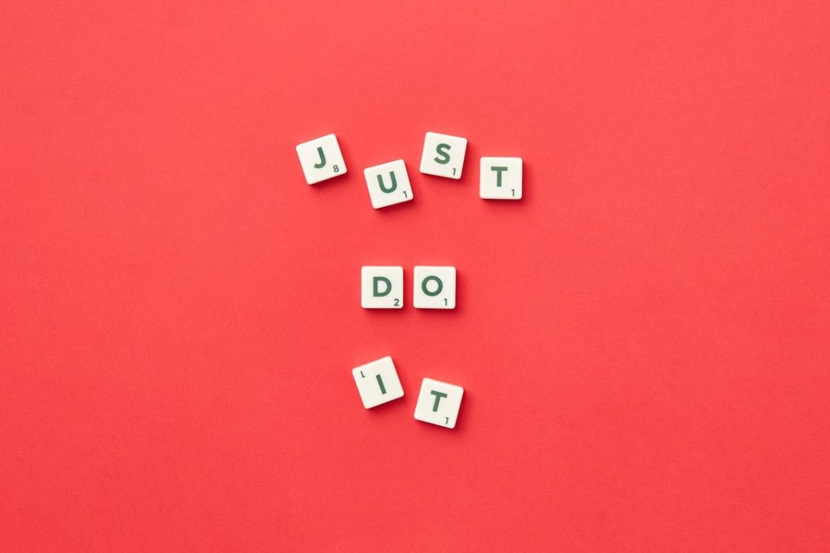 Bold Reminder: Embrace Action Over Endless Deliberation The phrase “Just Do It” written in bold on a red background, emphasising the power of action over excessive thought.