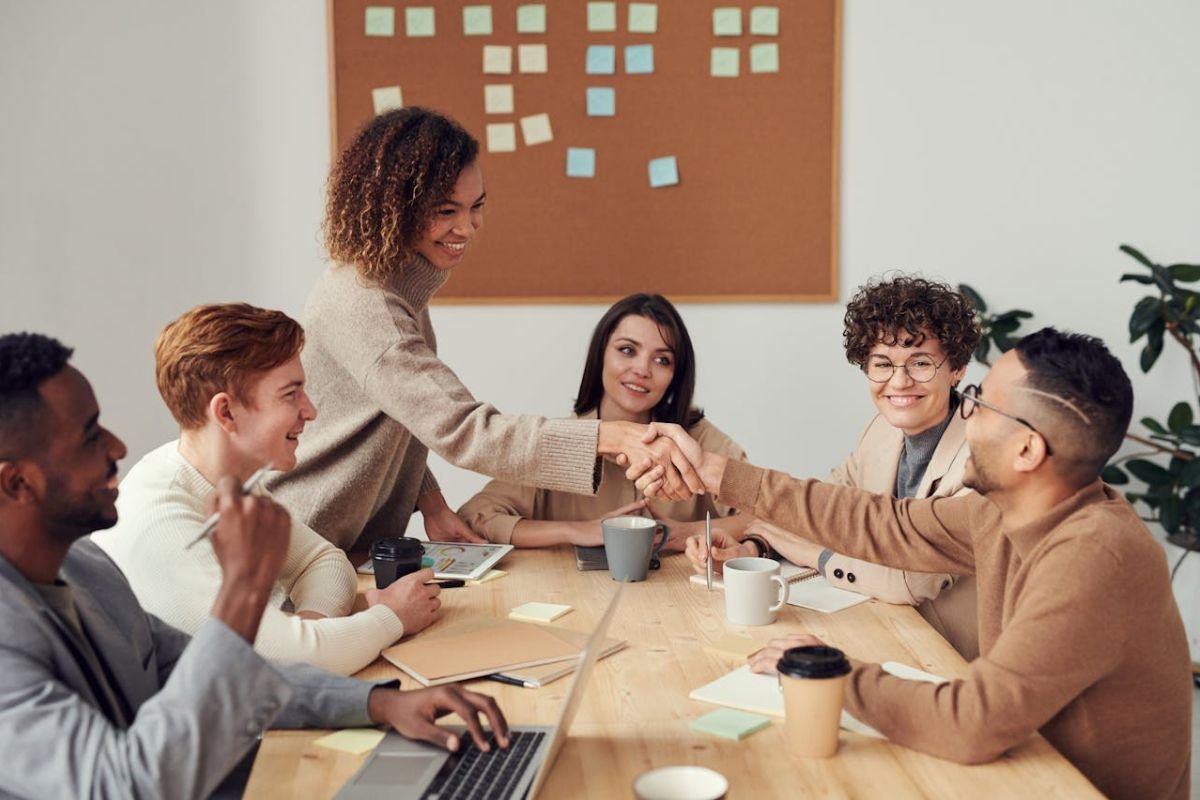 Colleagues Shaking Hands to Represent Collaboration Two colleagues shaking hands in an office setting, symbolising collaboration and mutual respect in relationships.