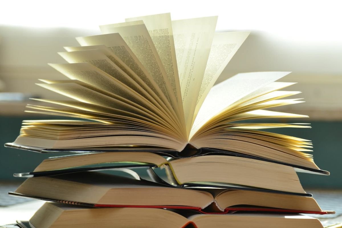 Stack of Books Representing Self-Development and Knowledge A stack of books in various colours and sizes, symbolising the pursuit of knowledge and personal growth.