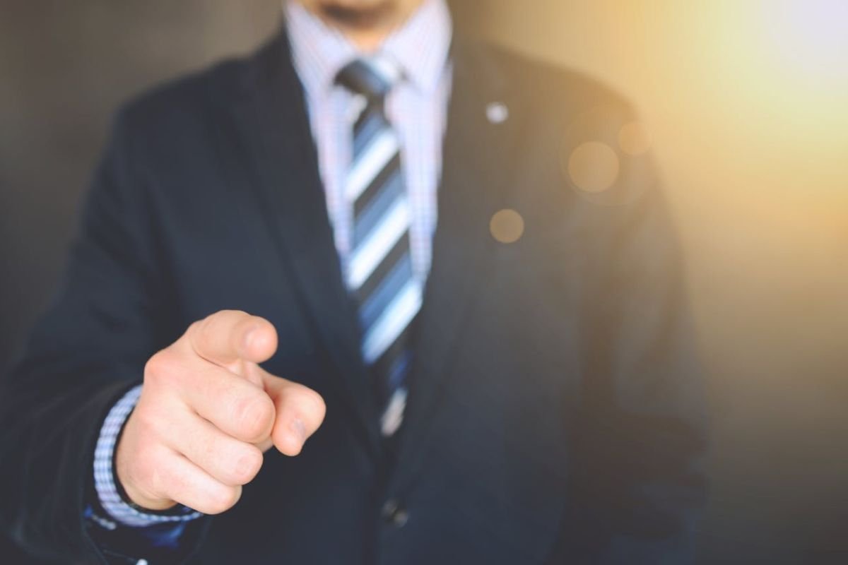 Suit Jacket Symbolising Authority: Why We Obey A close-up of a person wearing a suit jacket, symbolising authority and the psychological reasons behind obedience to authoritative figures.