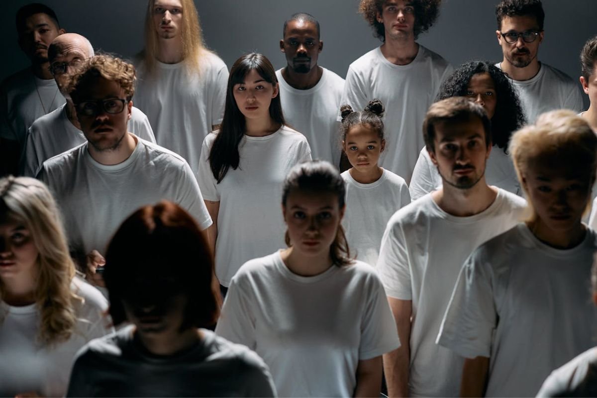 The Bystander Effect: Why Crowds Stay Idle A crowd of people standing together, illustrating the bystander effect where individuals are less likely to act in group settings.