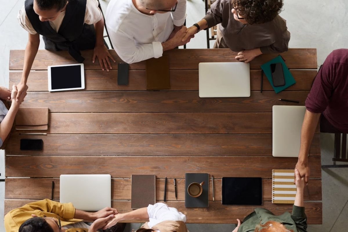 Keeping Career Wins Private: A Parent’s Guide to Discretion People shaking hands, representing career success and professional accomplishments, emphasising why parents should keep their children’s careers private.