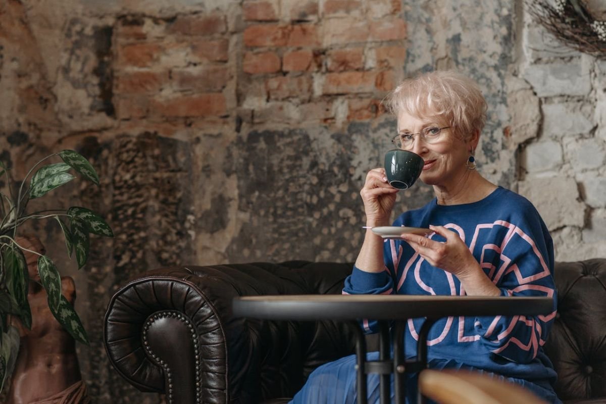 The Quiet Wisdom of Age: When Silence Speaks Volumes A serene image of a parent sipping coffee and smiling softly, symbolising inner peace, wisdom, and the power of intentional silence.