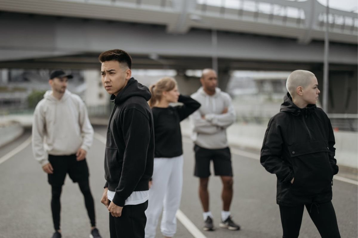 Following the Crowd: The Influence of Social Proof A group of people in active wear standing together, observing their surroundings, representing the concept of social proof and group influence.