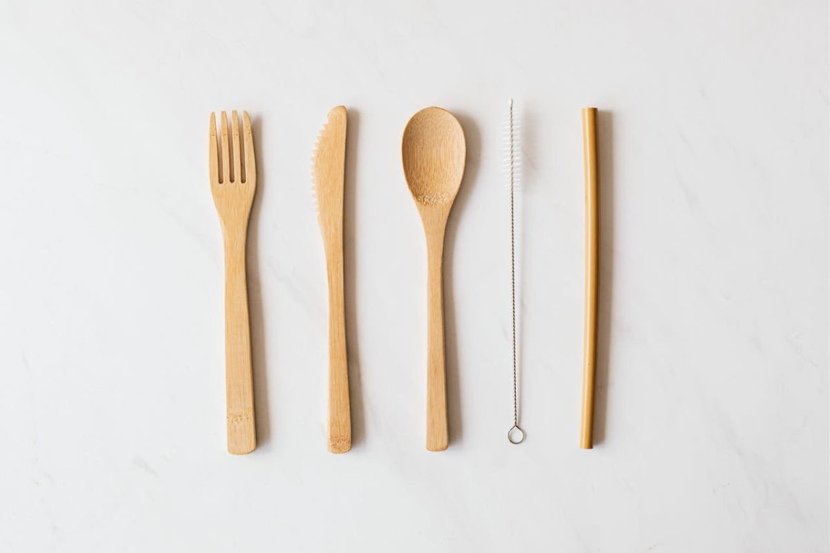 Influence as a Tool: Balancing Neutrality and Intent Wooden cutlery and a brush on a marble table, symbolising balance and neutrality, representing the dual nature of influence as a tool.