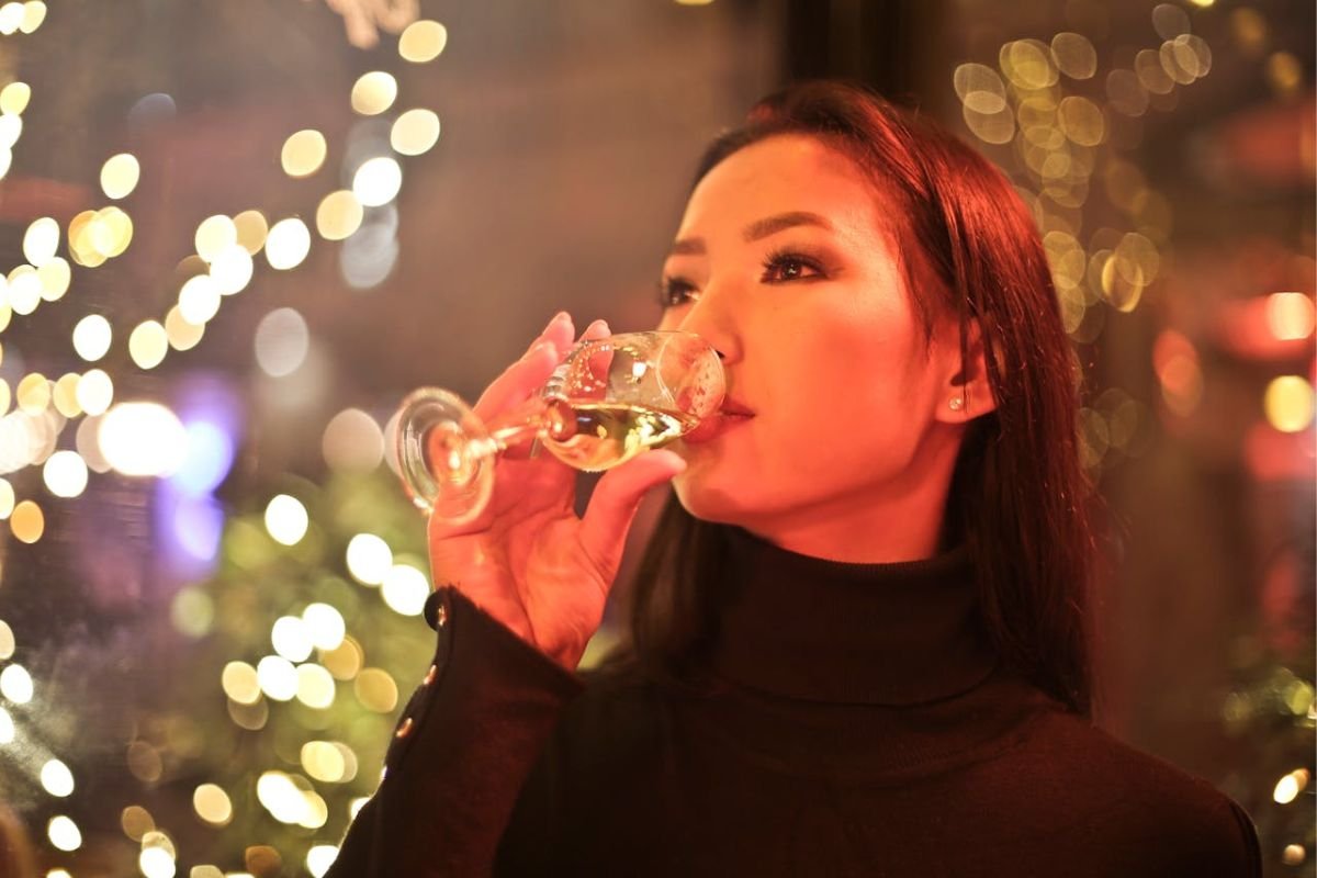 Woman Drinking Wine: Exploring Alcohol Tolerance and Cultural Enjoyment A woman confidently drinking wine, showcasing strong alcohol tolerance and social enjoyment.