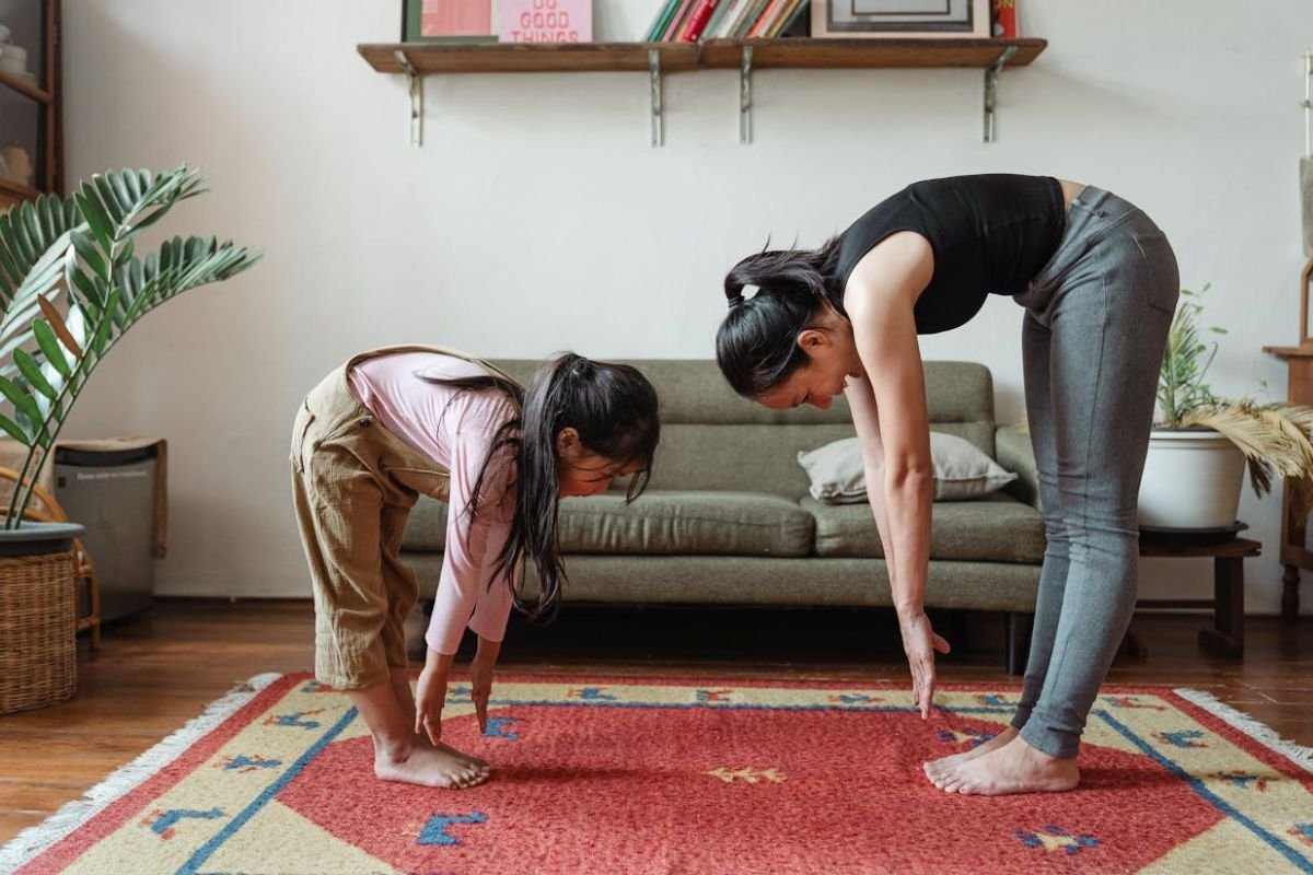 Embracing Health: A Woman and Girl Stretching Together for a Stronger Future A woman and girl stretching together, showing a commitment to health and well-being as they value good health.