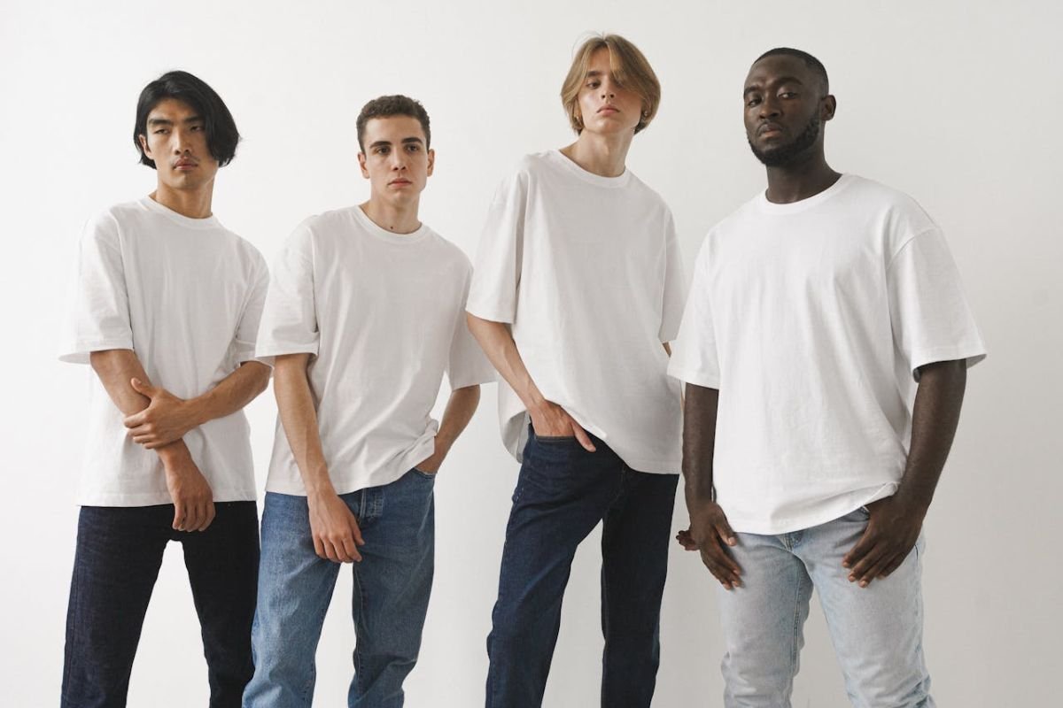 Decoding the Unspoken: How Subtle Poses Reveal Inner Feelings Four men stand in various casual poses, highlighting subtle body language movements that can reflect emotions and unspoken thoughts.