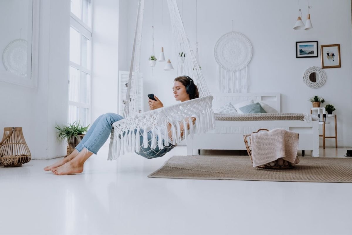 Feet Tapping Explained: A Sign of Excitement or Anticipation A woman comfortably seated, dressed in casual attire, listening to music and tapping her feet rhythmically, releasing energy with self-soothing movements.