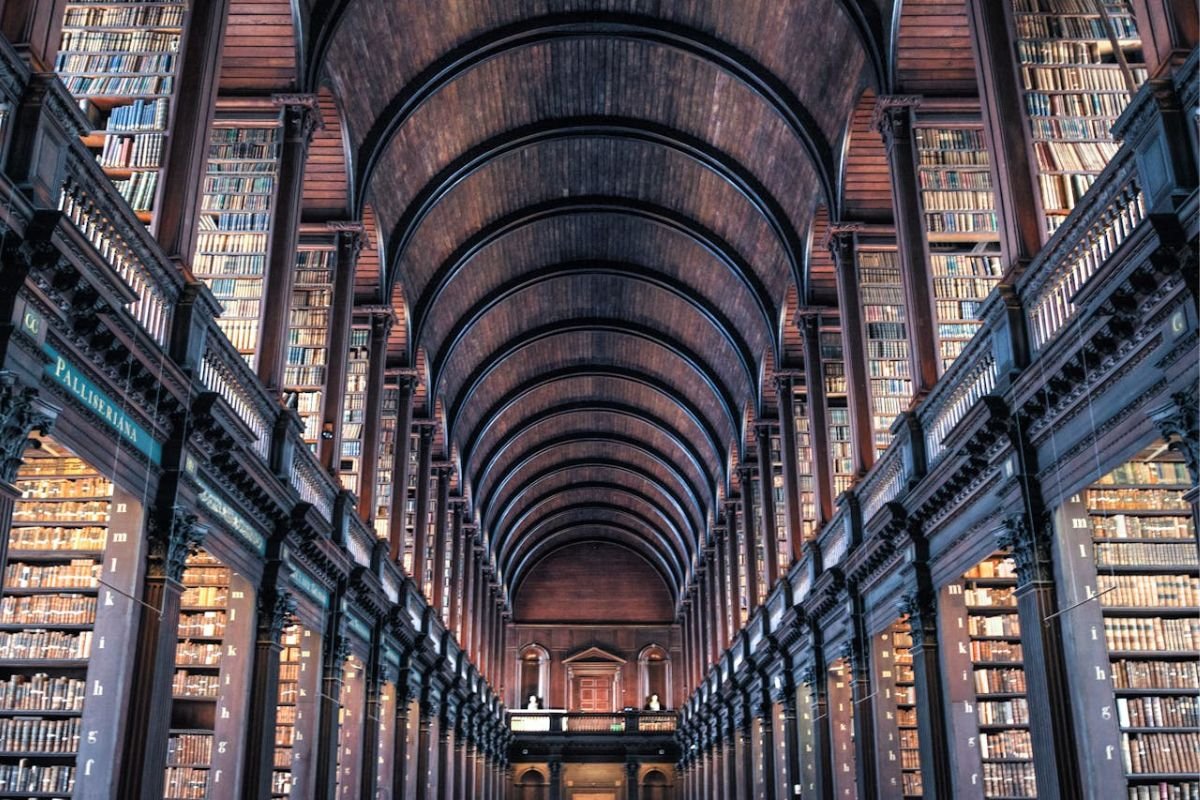 The Returning Book Mindset: Uncovering Solutions Through Reframing A library with shelves full of books awaiting relocation, symbolising the 'returning book mindset' and reframing challenges for unexpected solutions.