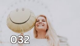A smiling woman holds a bright yellow smiley face balloon, symbolising joy and a heart uplifted by five happy sentences.