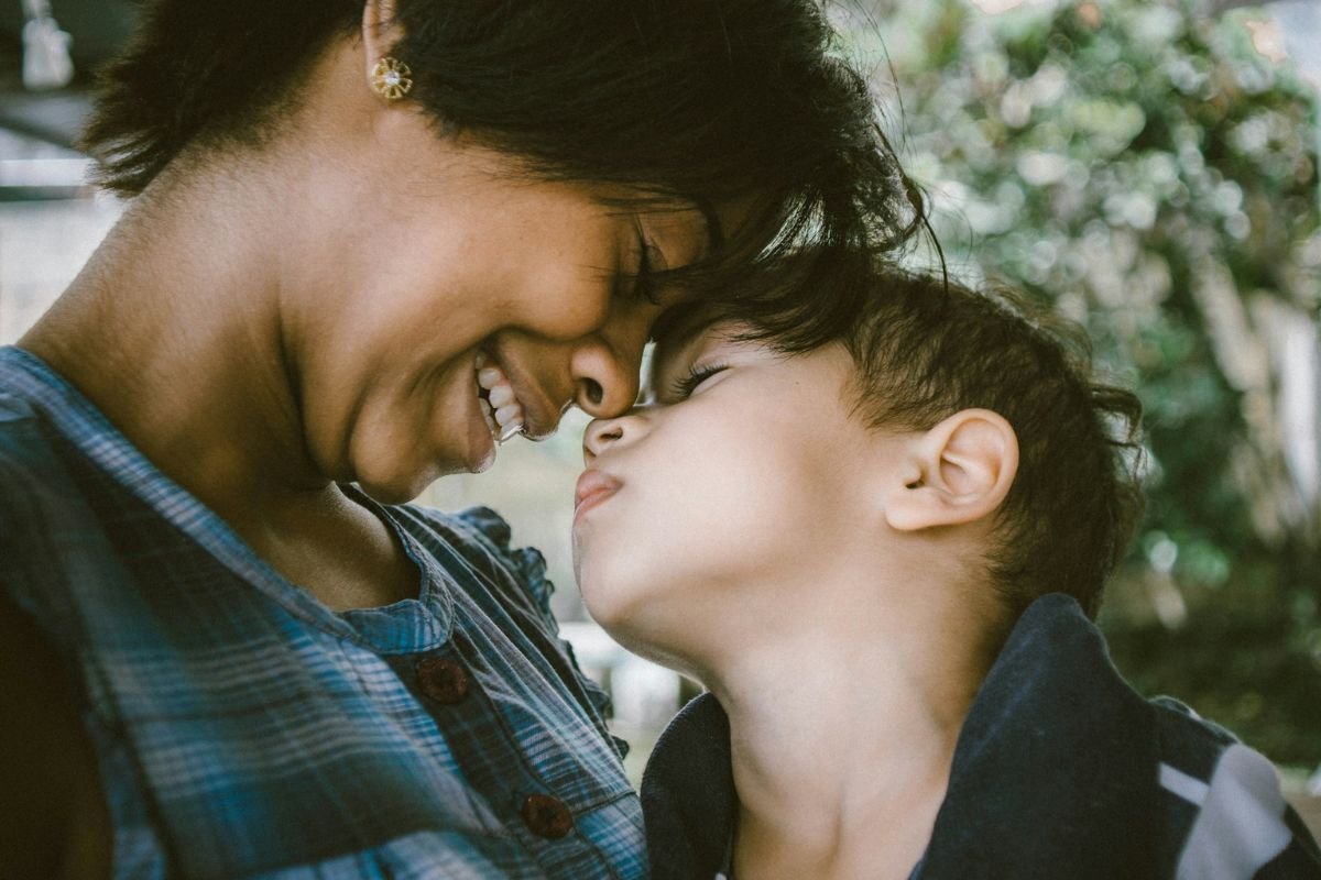 A Mother’s Steady Presence in a Child’s Life Close-up of mother and son sharing a gentle, emotional moment together.