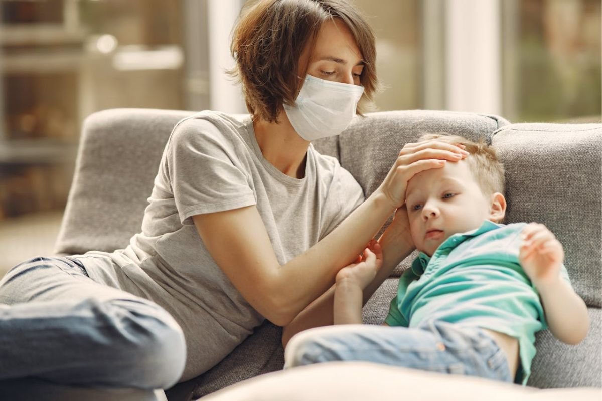 Miscommunication in Relationships: How Small Shifts Can Change Everything A tired mother checking her sick child’s temperature, symbolising the emotional strain of miscommunication in relationships.