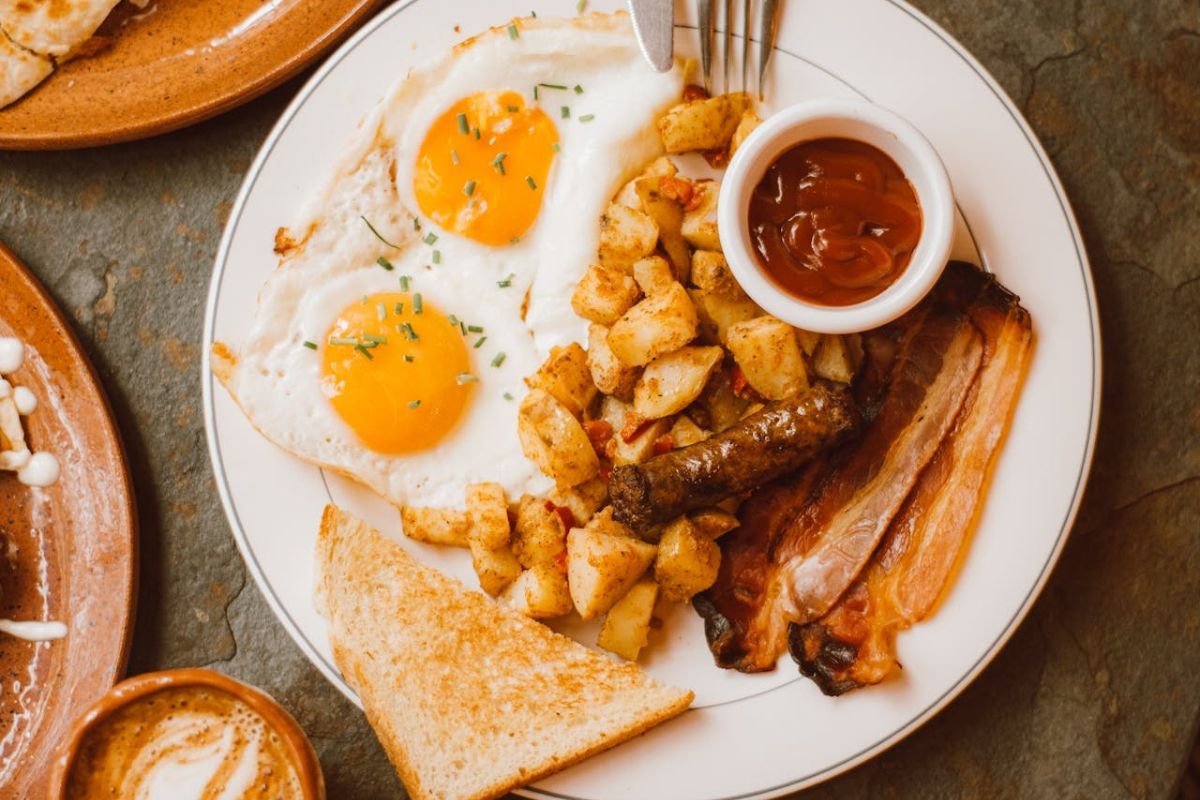 The Ultimate Breakfast Staple: Potatoes Done Right! A delicious breakfast plate featuring fried potatoes, eggs, sausages, bacon, and toast, showcasing the versatility of potatoes in everyday meals.