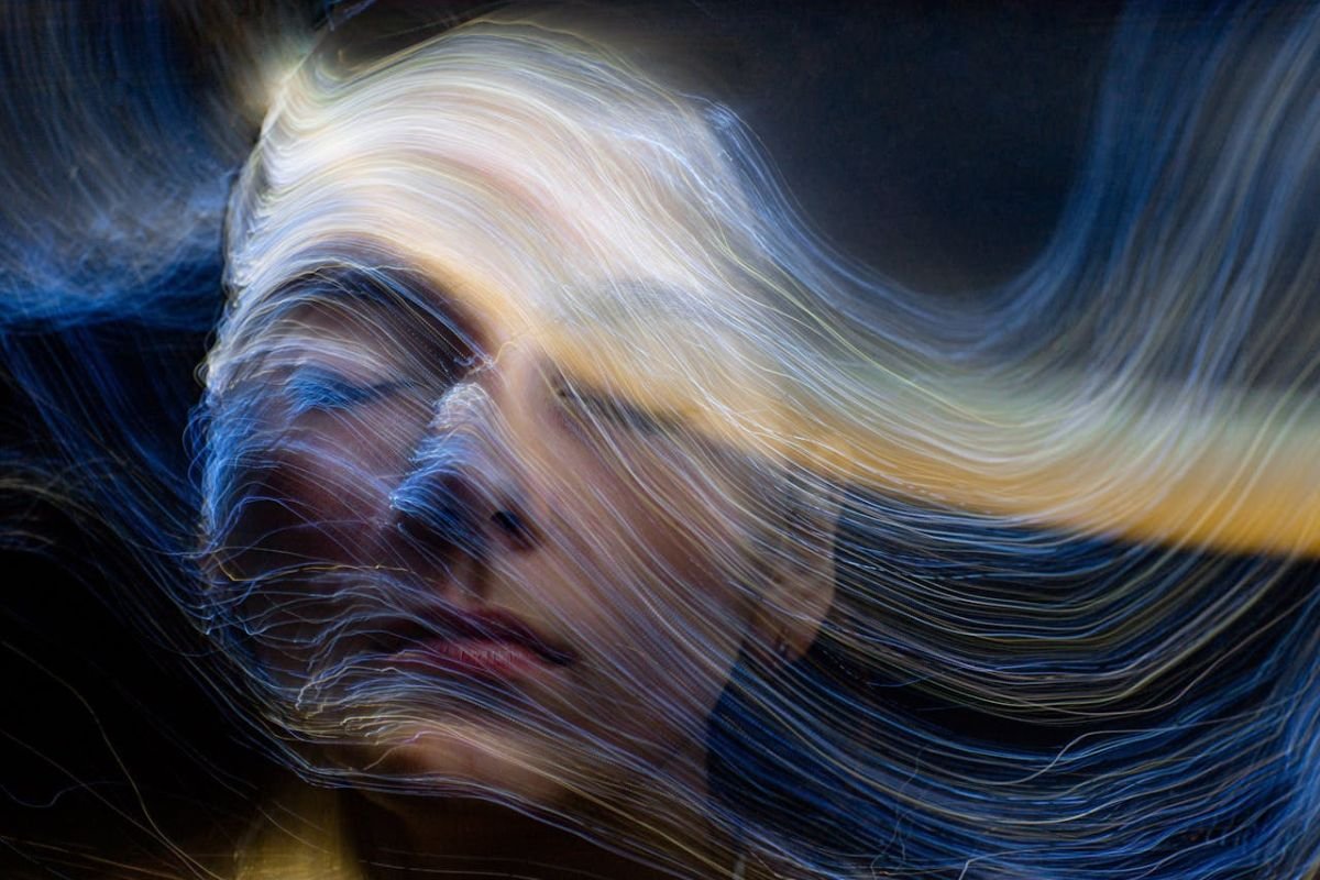 Embracing Energy: The Peaceful Strength of an Empath A serene woman surrounded by glowing energy waves, symbolising her peaceful connection to emotions and empathic energy.