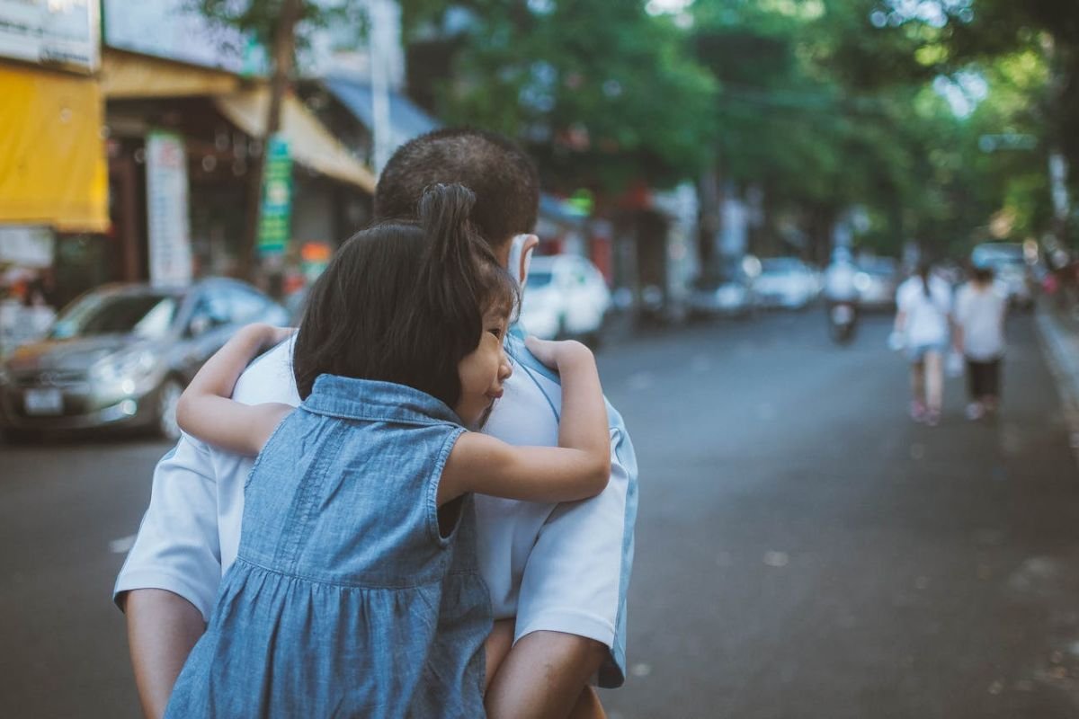 Carrying with Purpose: A Visual of Strength and Responsibility Father giving daughter a piggyback ride, symbolising strength, care, and the ability to carry responsibility with love.