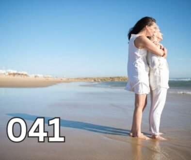 Elderly mother and adult daughter hugging affectionately on the beach, symbolising a deep, loving bond across generations.