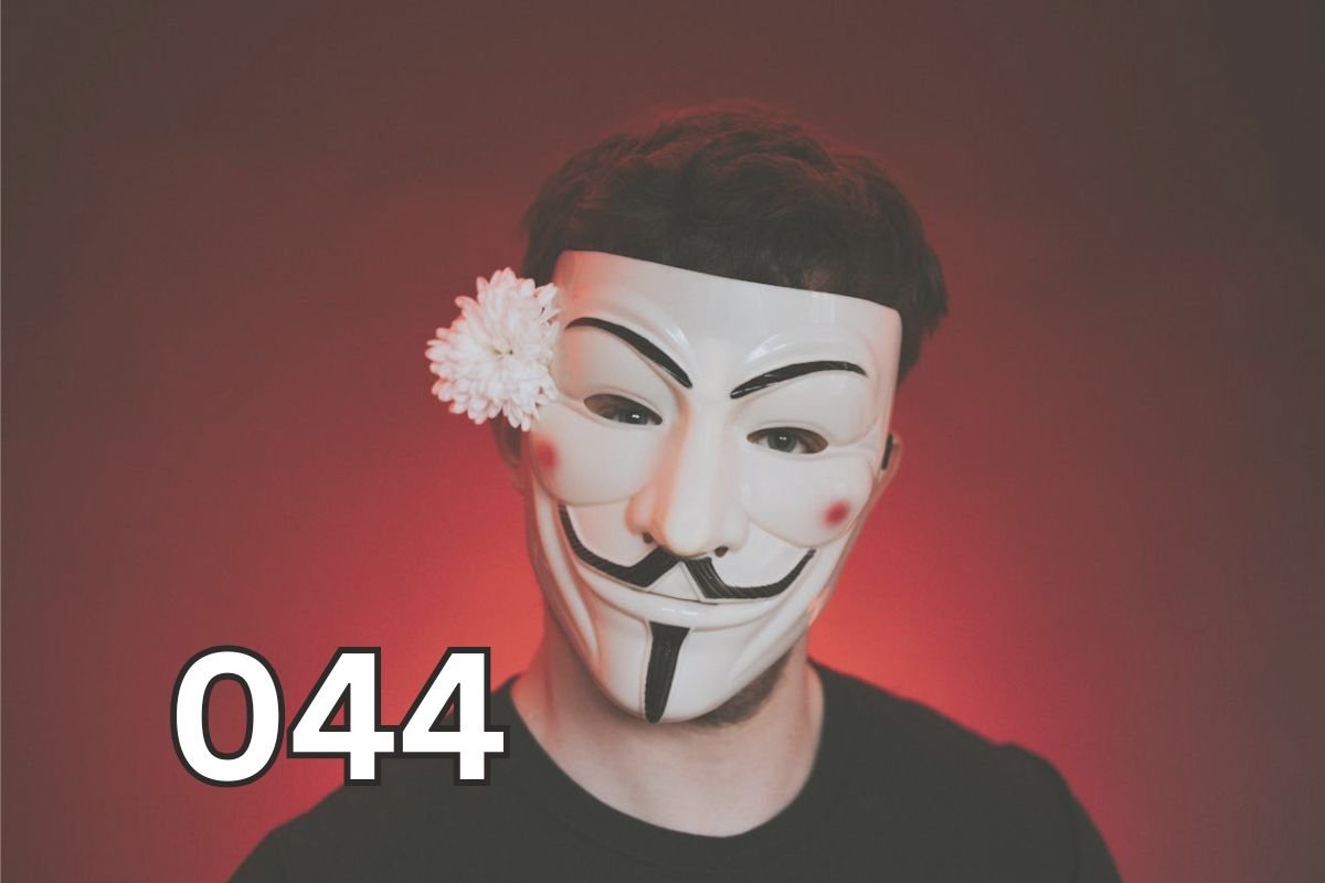 Person wearing a Guy Fawkes mask with a flower, symbolising hidden traits of antisocial personality disorder.