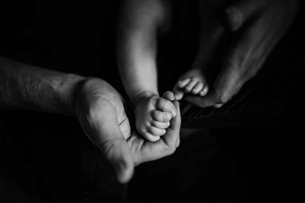 Newborn Baby’s Feet Held by Parents. Symbol of Innocence and Emotional Beginnings Close-up of a parent gently holding a newborn’s feet, symbolising innocence, care, and the beginning of our emotional story.