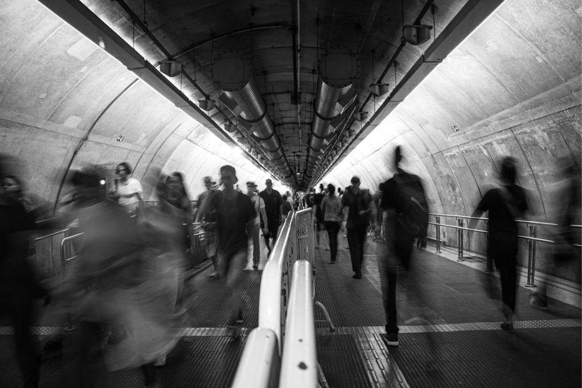 The Hidden Among Us: ASPD in Plain Sight Blurred people walking through a tunnel, illustrating how individuals with antisocial traits can move unnoticed among us.