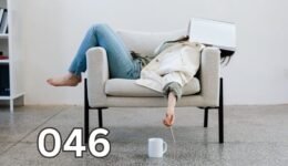 Exhausted woman lying on a couch with a notebook over her face, capturing silent burnout and emotional fatigue