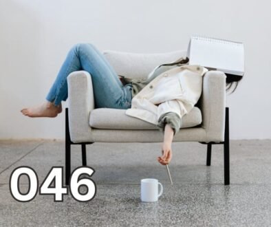 Exhausted woman lying on a couch with a notebook over her face, capturing silent burnout and emotional fatigue