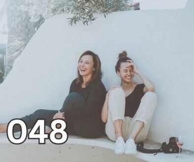 Two women laughing and bonding on a bench, symbolising instant connection and likability through shared joy and presence.