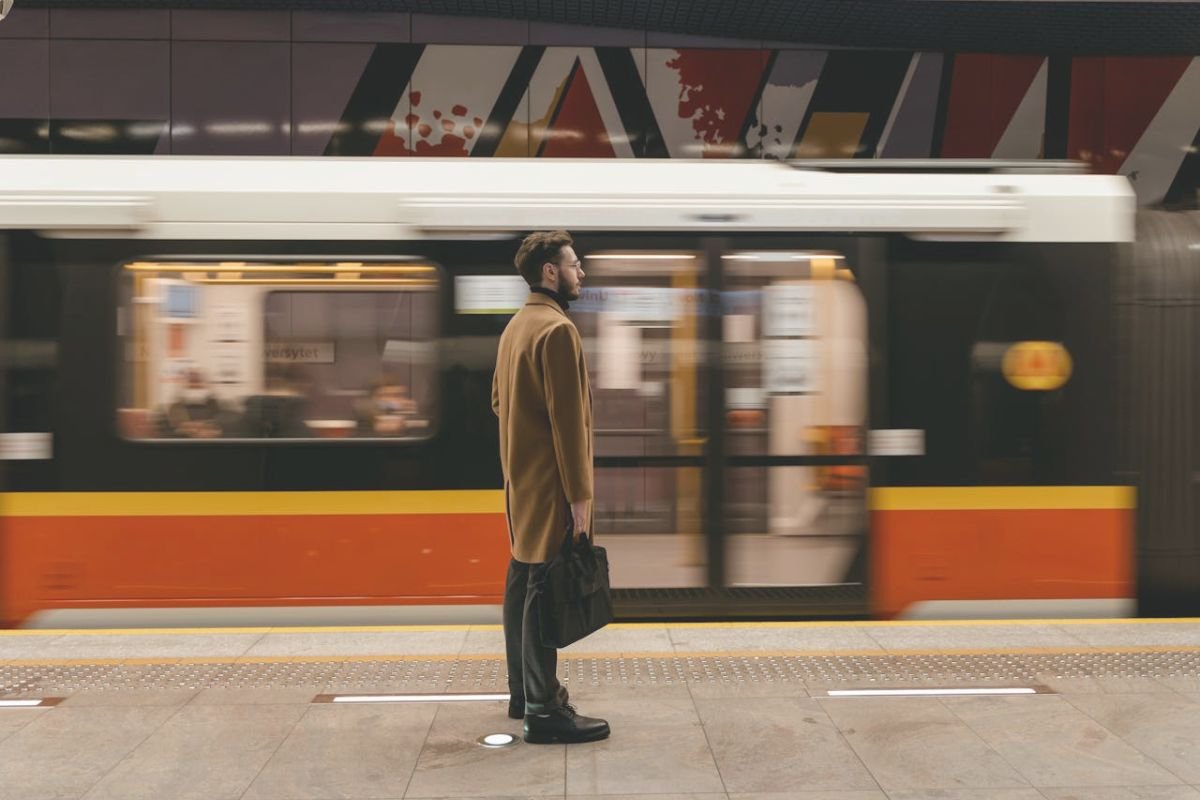 The Mere Exposure Effect – Why Familiar Faces Make Us Feel Connected Man standing alone on a subway platform watching a train approach, subtly reflecting concern over the absence of a familiar face.
