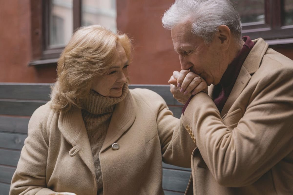 Elderly couple sitting together on a bench, representing a lifetime of love, companionship, and a lasting marriage legacy
