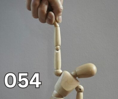 A wooden mannequin being controlled by a hand, symbolising emotional manipulation and loss of self-control.