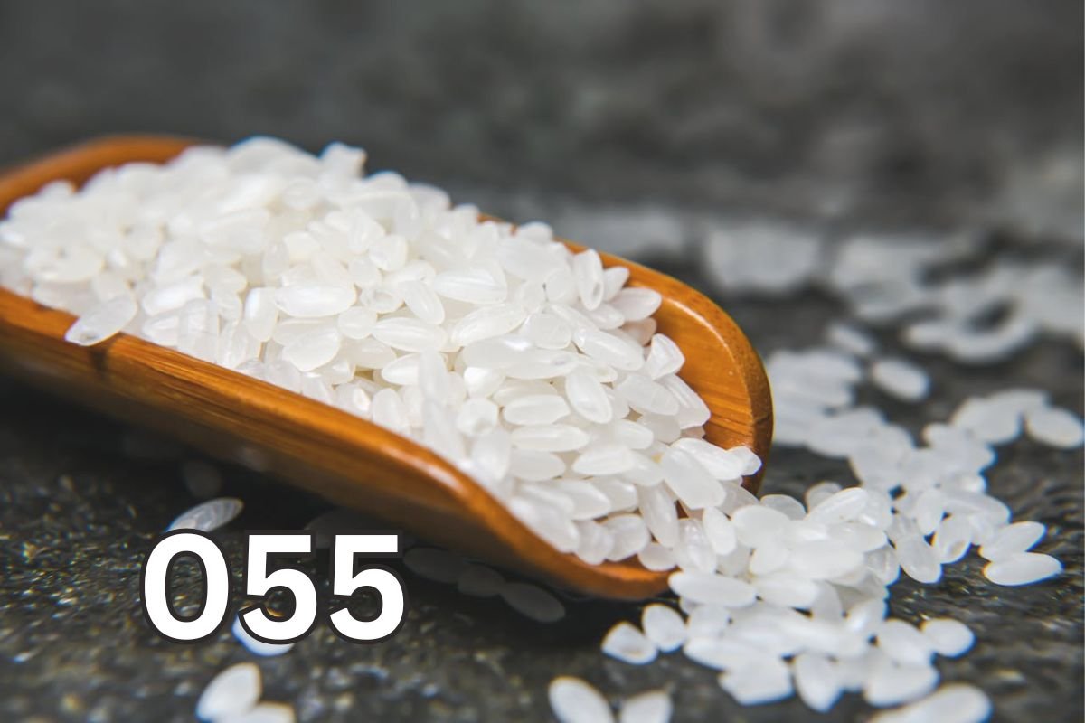 Wooden Scoop Filled with Raw Rice Grains Raw rice grains in a wooden scoop, close-up view