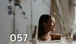 Elderly woman sitting quietly by a sunlit window, her posture calm and reflective, embodying peace and quiet reflection.