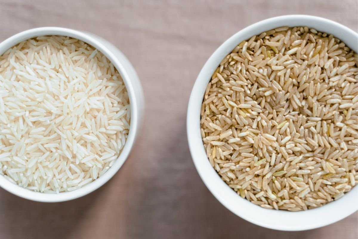 White Rice vs Brown Rice in Ceramic Bowls Two white ceramic bowls with white rice on the left and brown rice on the right