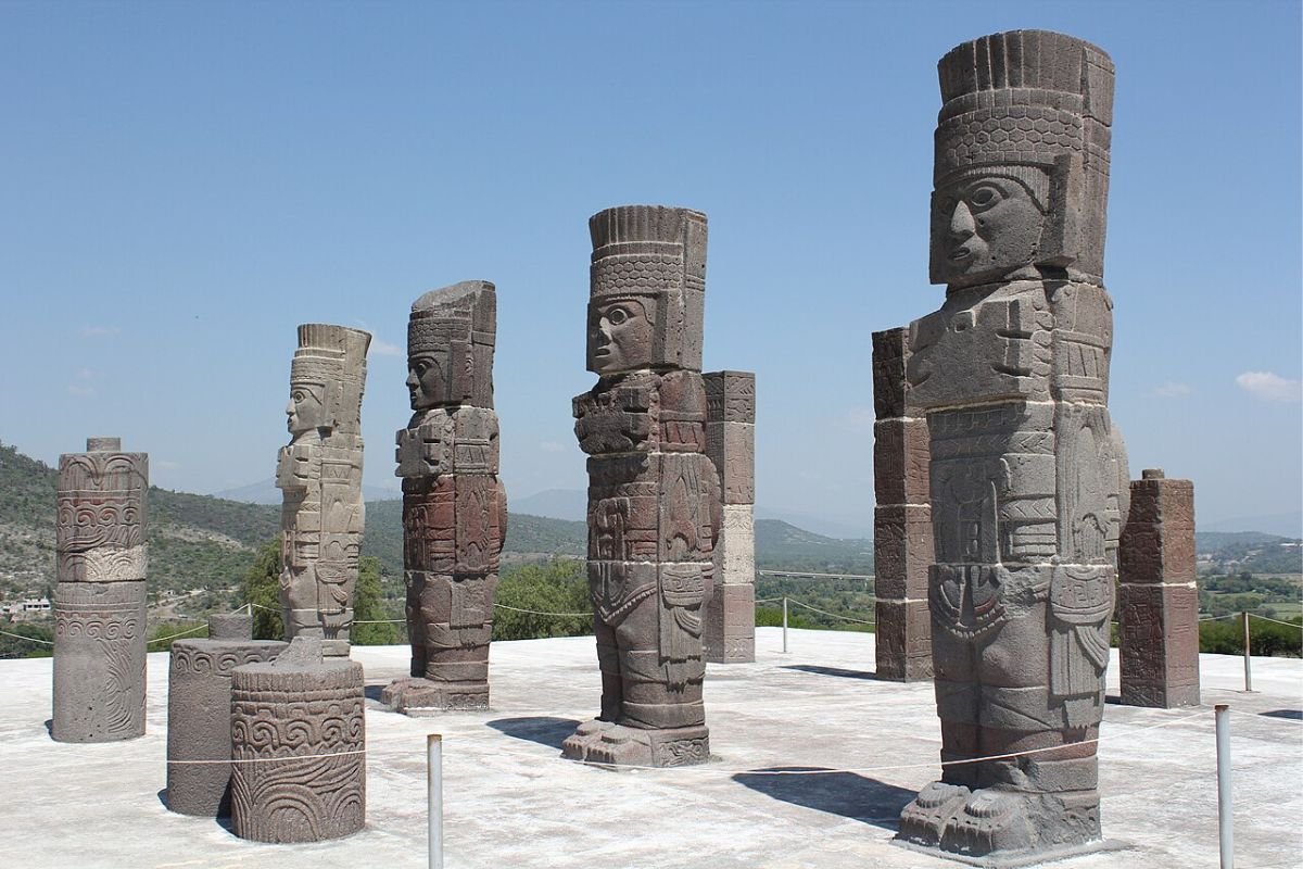 Stone statues of the four Atlantean warrior figures standing on top of Pyramid B in Tula, Mexico.
