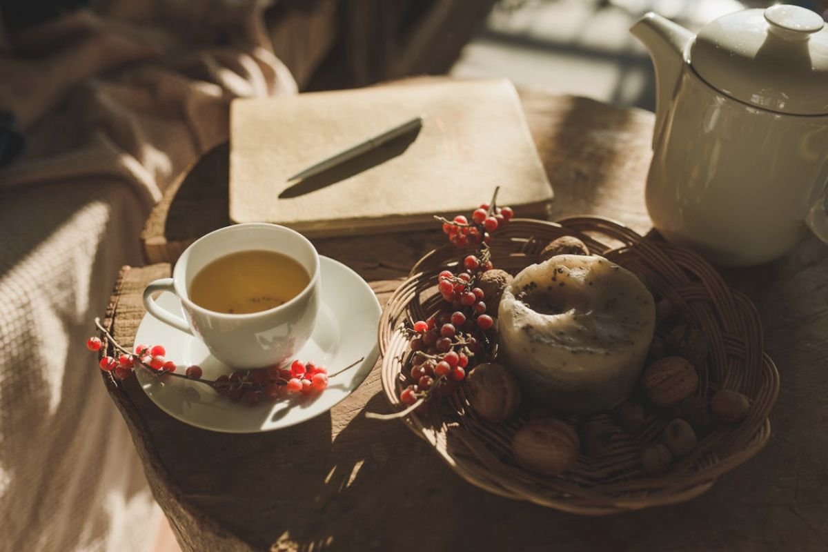 Cozy bedside scene with notebook, tea cup, and morning light