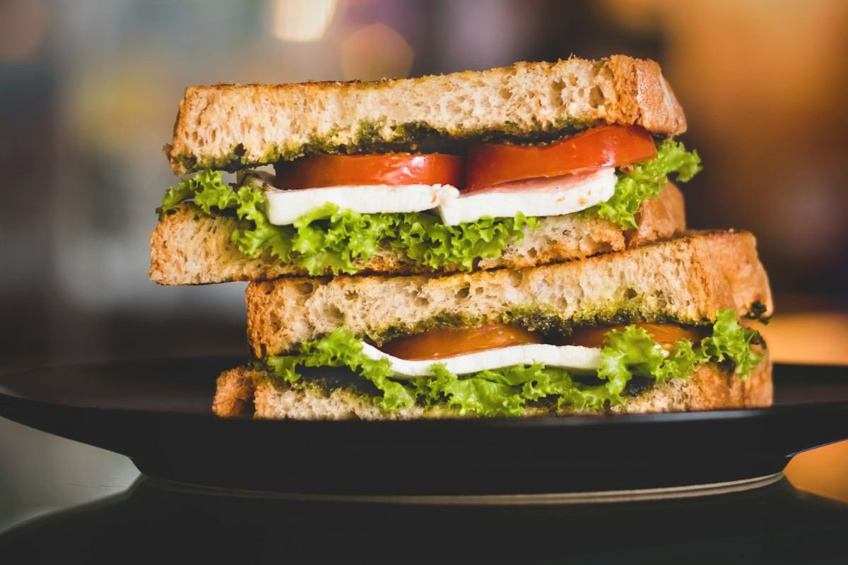 Simple sandwich on a black plate, minimalistic lunch in neutral tones