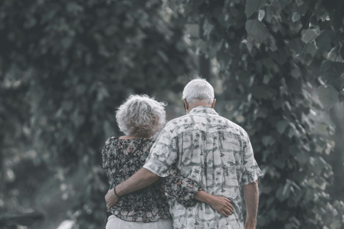 Older couple walking together outdoors in daylight