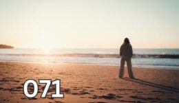 Woman standing alone on beach at sunset, silhouette by calm sea