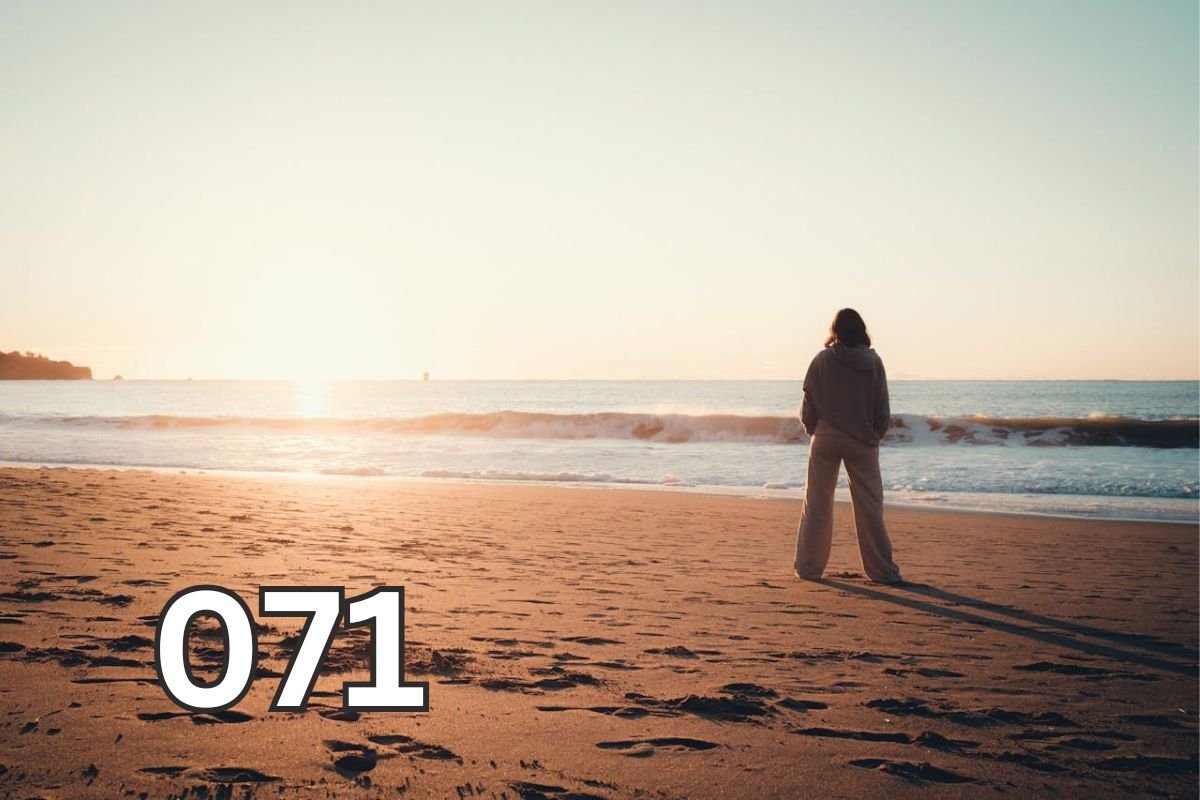 Woman standing alone on beach at sunset, silhouette by calm sea