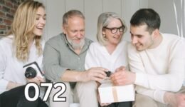 A happy family of four: two elderly parents and two adult children, smiling together, symbolising peace and harmony in family relationships.