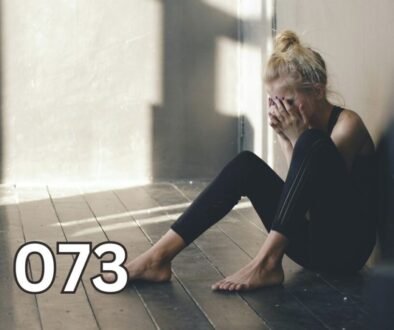 Woman sitting on floor covering her face, heartbroken and reflective